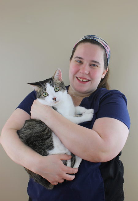 Adrienne holding a black and white cat. Image from Beechmont Pet Hospital's old website.