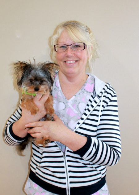 Liz holding a small dog. Image from Beechmont Pet Hospital's old website.