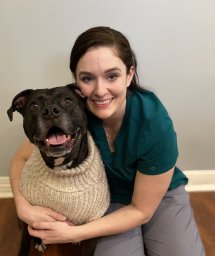 Michelle posing with a dog in a sweater. Image from Beechmont Pet Hospital's old website.