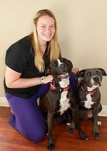 Sara. F posing with two dogs. Image from Beechmont Pet Hospital's old website.